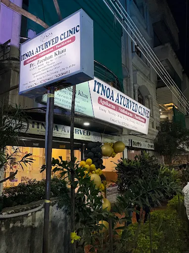 Alternate evening view of ITNOA Ayurved Clinic signage and entrance